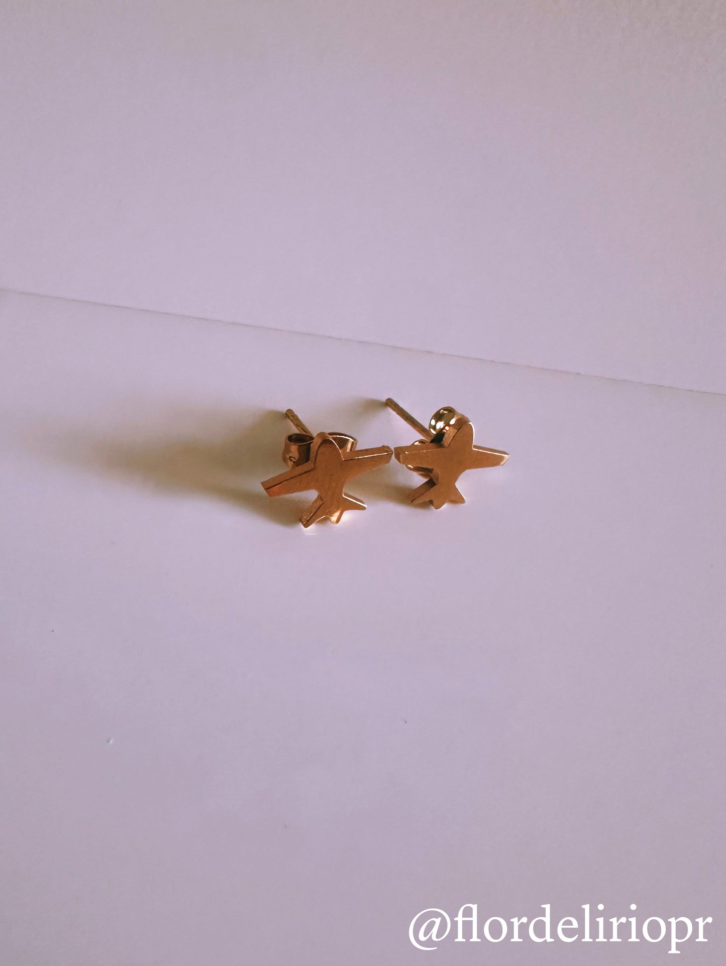 Gold airplane earrings